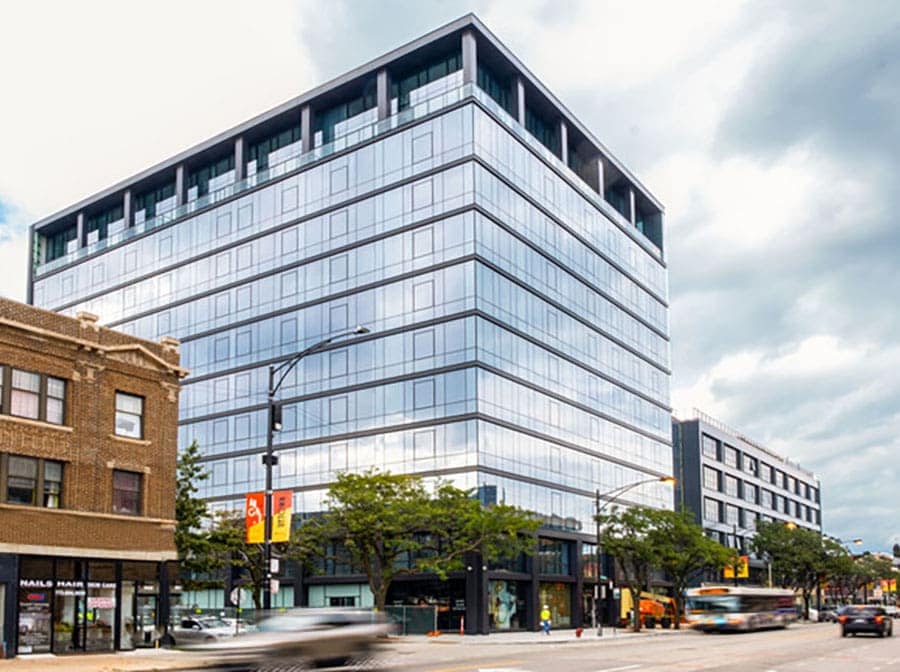 10-story glass commercial building with ground floor retail