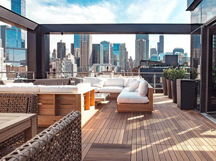 Rooftop lounge with plush furniture and city views